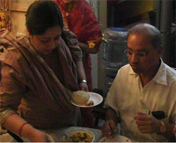 member take a taste of the food cooked by the new bride, while she waits for their comments
