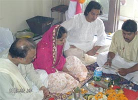 A typical Bihari groom performing satyanaran katha with his parents