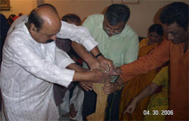 Here five senior married men establish the 'harish' in the centerspace of the mandap while others watch.