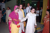 the brother leads his sister and her groom to the bedecked 